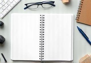Notebook and pen on a desk for podcast planning